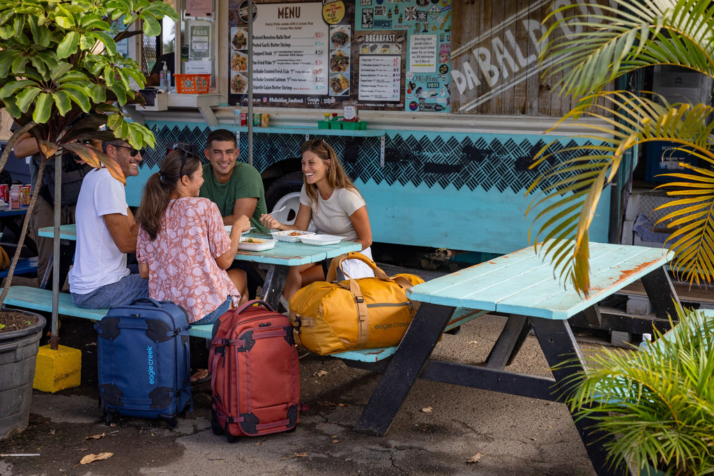 Friends feast together around a picnic table